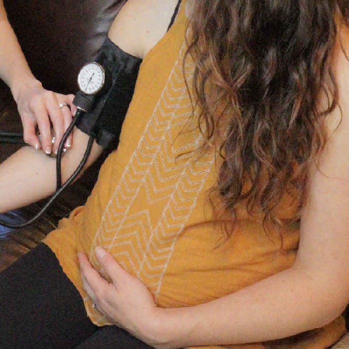 midwife checking blood pressure